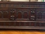 a large wooden chest sitting on a hard wood floor
