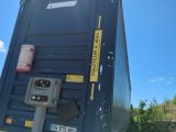 an image of a blue container truck parked on the side of the road