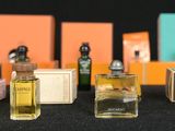 several bottles of perfume are lined up on a table