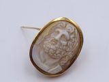 a close up of a ring with a face of a man on it