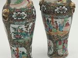 pair of chinese vases on a white surface with a white background