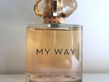 an image of a bottle of perfume sitting on top of a table