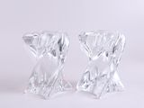 pair of clear glass candlestick holders on a white background