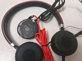headphones with a cord are sitting on top of a table