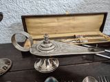 a silver plate with spoons and spoon rest on a table