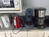 many different types of coffee makers on the kitchen counter