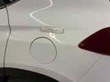 a close up of a white car with a sticker on it