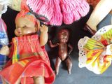 a lot of dolls that are sitting on a table