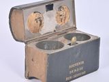 a box with two bowls inside of it on a white surface