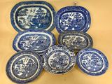 six blue and white plates with animals and trees on them