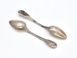 pair of silver spoons on a white background
