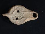 an image of a small piece of pottery on a black surface