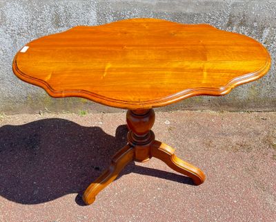 a small wooden table with a wooden top on a sidewalk