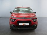 the front of a red citrole parked in a showroom
