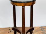 an image of a small table with a marble top on a wooden floor