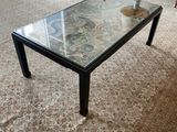 a coffee table with a glass top in a living room