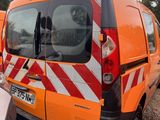 a van that is parked in a lot with other vehicles