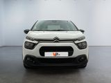 the front of a white citrole car parked in a showroom
