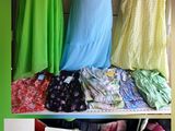 three pictures of dresses on display on a rack