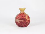 a small vase with a red and yellow design on it