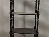 an image of a black shelf with three shelves on each side