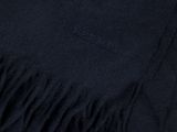 a close up of a black blanket with a fringe on it