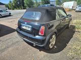 a small black car parked on the side of the road