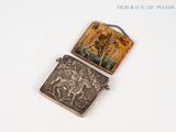 a small silver box with a picture of a man on it