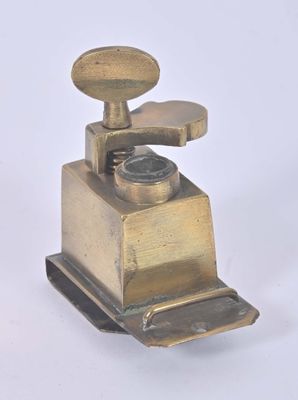 a small metal grinder with a wooden handle