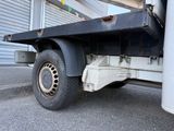 an image of a flatbed truck parked in front of a garage