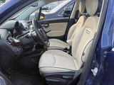 the interior of a car with the door open and the driver ' s seat down