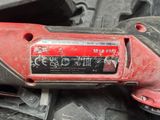 a red corded drill that is sitting on top of a pile of other tools