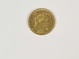 a close up of a gold coin on a white surface