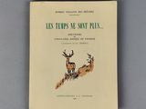 un vieux livre avec une illustration représentant deux cerfs courant sur une colline