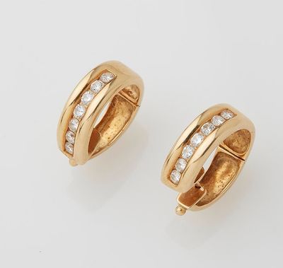 a pair of gold and diamond hoop earrings