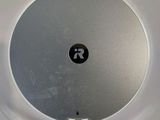 a close up view of a round object with a button on it