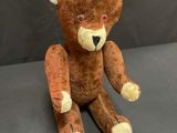 a brown teddy bear that is sitting on a table
