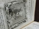 an old book with a picture of a dog on it