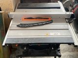 a table with a saw on top of it in a garage