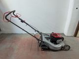 a small lawn mower that is sitting on the floor
