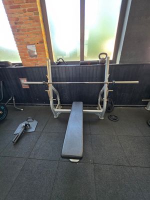 a gym room with a bench, weights, and other equipment