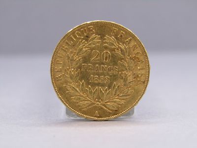 a gold coin sitting on top of a white surface