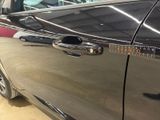 a close up of a car door handle with a sticker on it