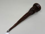 an image of a wooden stick with a handle and a tag on it
