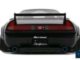 the back end of a black toy car on a white background