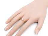 a close up of a person ' s hand with a ring on it