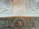 a close up of a bronze vase on a marble table