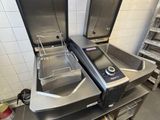 two stainless steel ovens in a kitchen with tiled walls