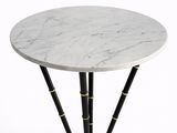 une table en marbre blanc avec des pieds en bambou noir et un socle doré