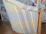 a chair that is sitting in front of a wallpapered wall